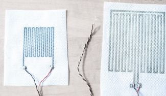 Two white fabrics covered with regular black designs produced using digital printing technology.