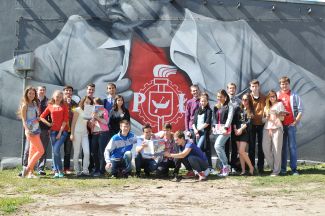 Studenci na tle muralu