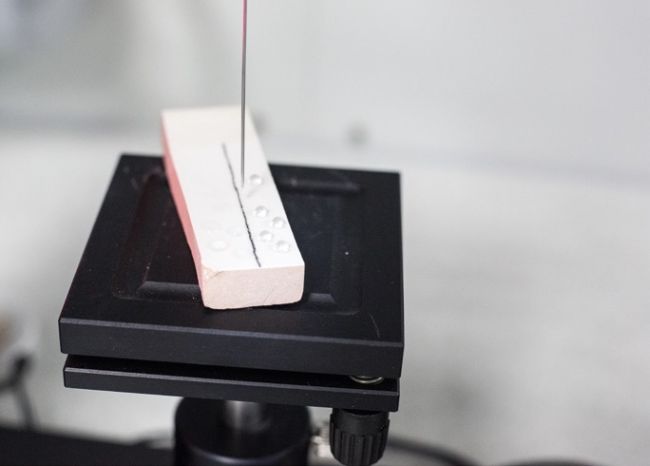 Overview photo: a section of black tile with white rectangular piece lying on top.